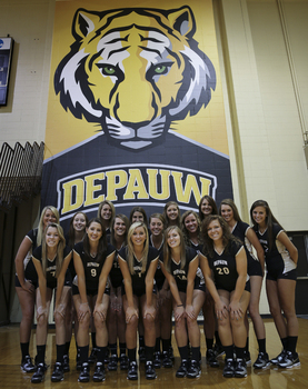 DePauw volleyball team in front of Tigers banner
