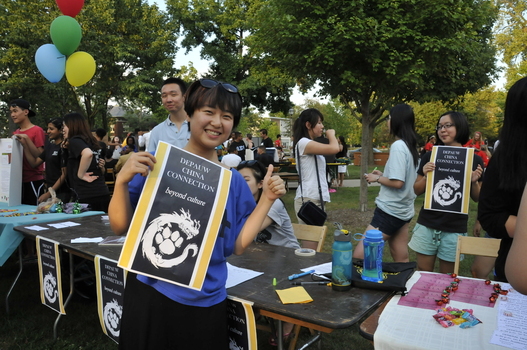 Student smiling with China Connection advertisement