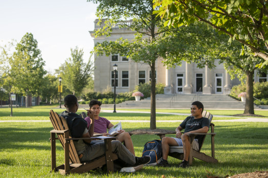 Students sitting outside on the East College Lawn