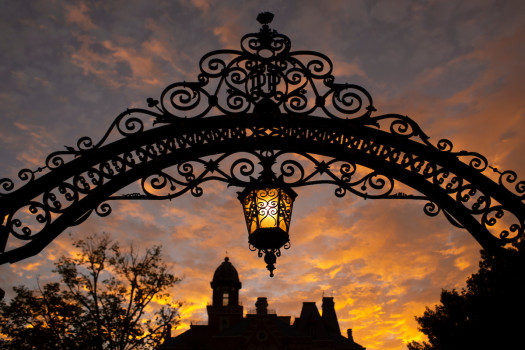 The alumni gates on Locust Street at dusk