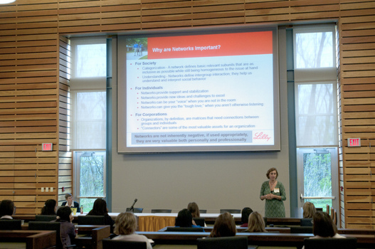 A group presentation with a slide presentation in the background