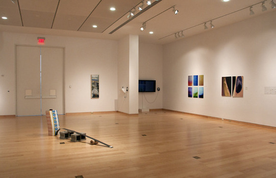 Peeler gallery with exhibit art on the wall and positioned on the floor