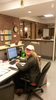 Student smiling while working at the help desk