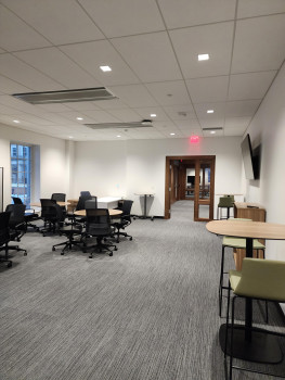 Q Center work area with table and chairs with alternate entrance doorway in the background