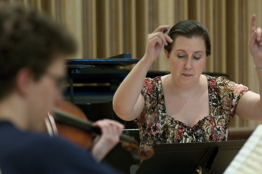 Students playing violin during classroom session