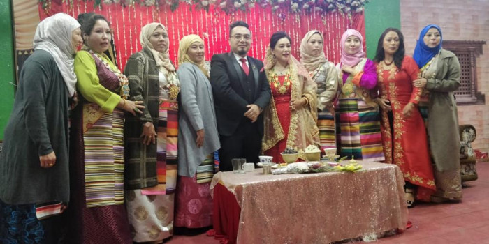 Group of people posing together in front of a table