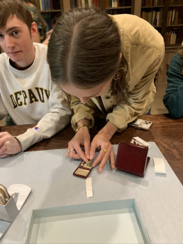 9 Reading the world's smallest book? With an appropriately diminutive magnifying glass?