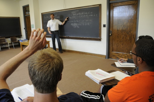 Student asking a question during classroom lecture