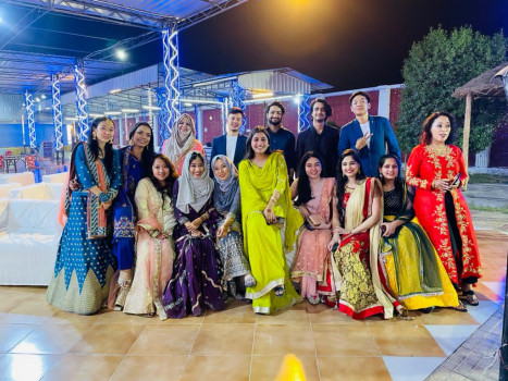 Group of people posing together at night