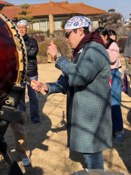 A student is trying out traditional Japanese drums at a winter term in Japan
