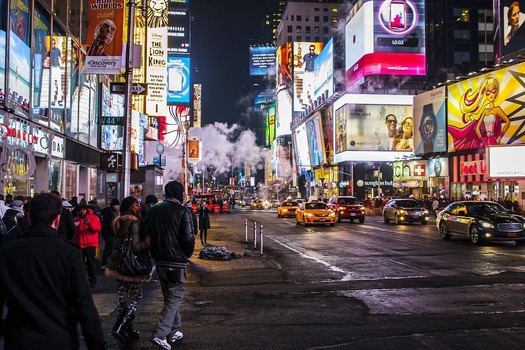 Times Square in New York City illuminated with billboards at nighttime. 