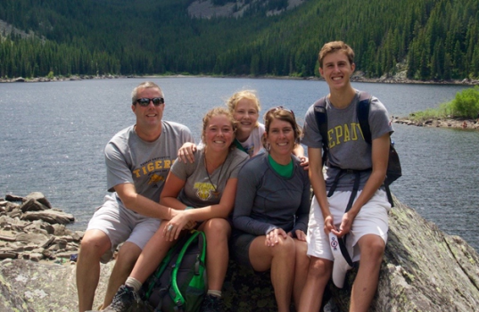 Dr. Bill Dillon, Sally Clark Dillon, and family with a lake background