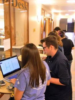 Students preparing their laptops for campus technology at the beginning of the academic year.