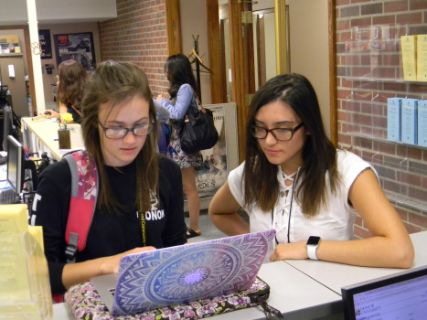 Client Information Specialist helping a student.