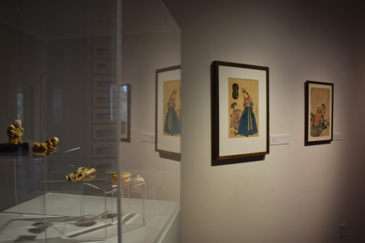 Miniature ivory faces and prints behind them