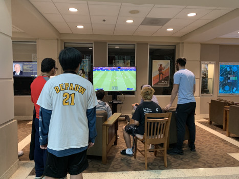 Students gathered around a round of FIFA