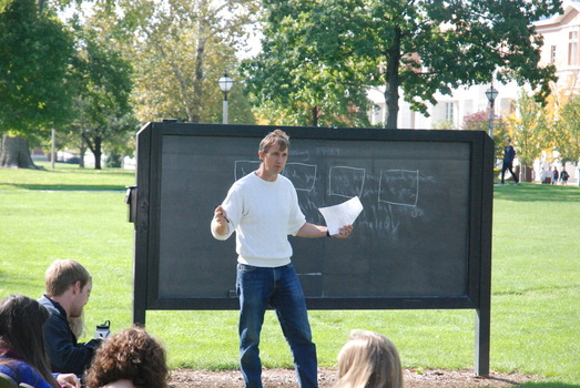Joe Heithaus teaching outside in front of a chalkboard