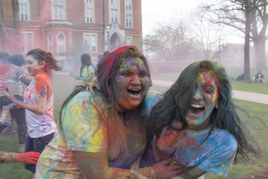 Interfaith Council Members Kainat Akmal '17 and ShelleyAnn Simon 17' celebrate the Hindu Holiday, Holi, on East College Lawn.