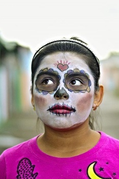 Woman with face paint of a skeleton for a Day of the Dead celebration.