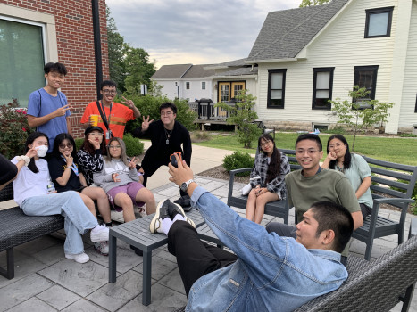 Students sitting around a table smiling