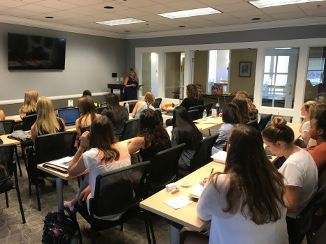 Presenter speaking to a group of students