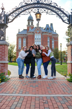 The council hugging in front of the East College building 