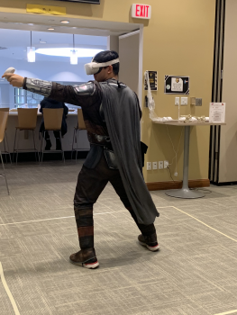 Student playing VR in a Mandalorian costume.