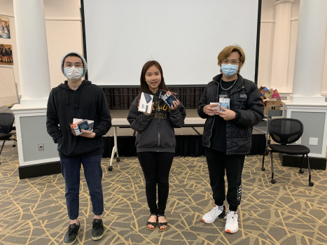 Three contest winners holding prizes.