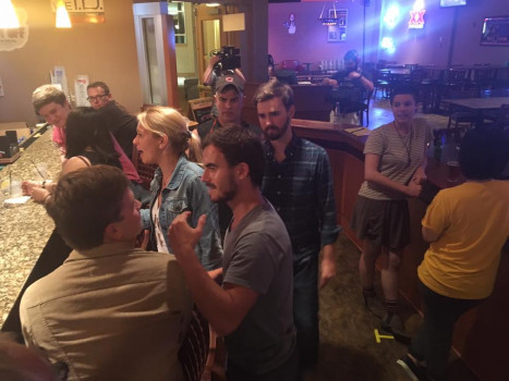 people standing by a bar counter