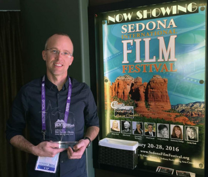 person standing in front of movie poster for beauty and the beast