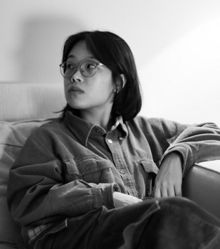 black and white photo of female sitting not looking at camera