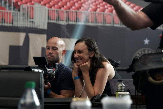 two people smiling looking at video camera