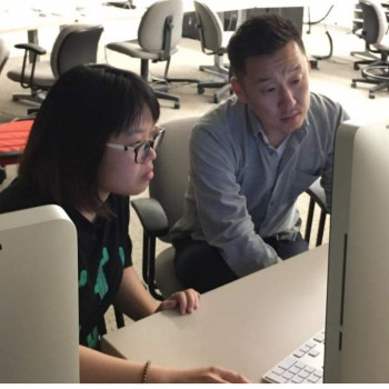 two people looking at computer monitor