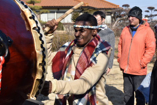 Student beating on a drum