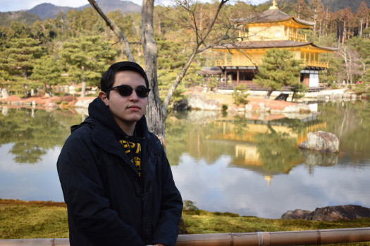 Student with scenic lake background