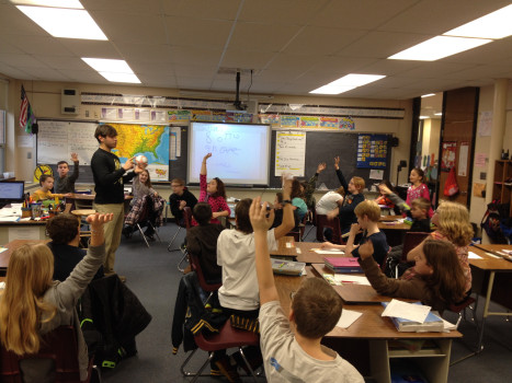 A DePauw student teaching a group of elementary children.