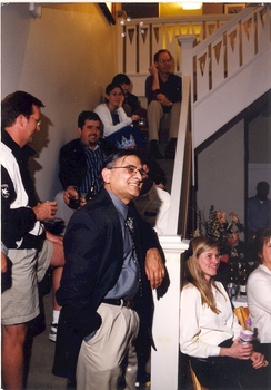 Faculty members lined up around a stairway at a gathering