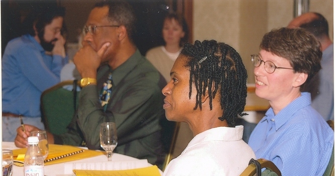 Faculty members listing to a speaker during a meeting