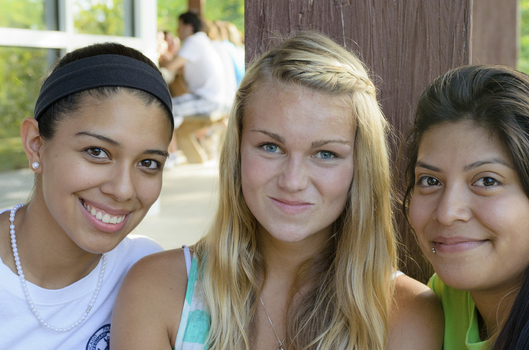 Three students smiling