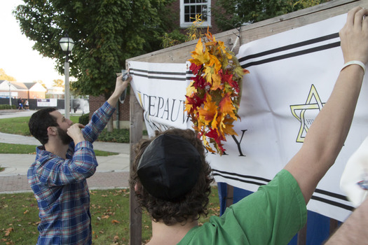 Adding finishing touches to the Sukkah