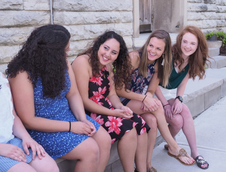 The council sitting and looking at each other while smiling