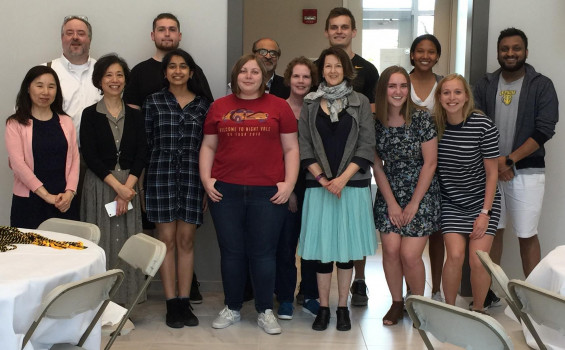 Group of students and professors posing at the year end dinner