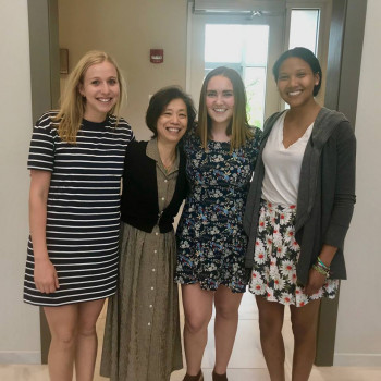 Three students and professor at the year end dinner