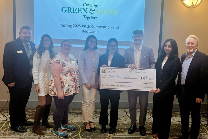 Pitch Competition winners holding winning check along with staff/faculty 