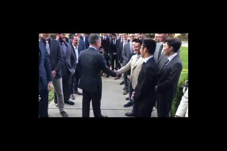 Juan Manuel Santos shaking hands with students at DePauw's Delta Upsilon House