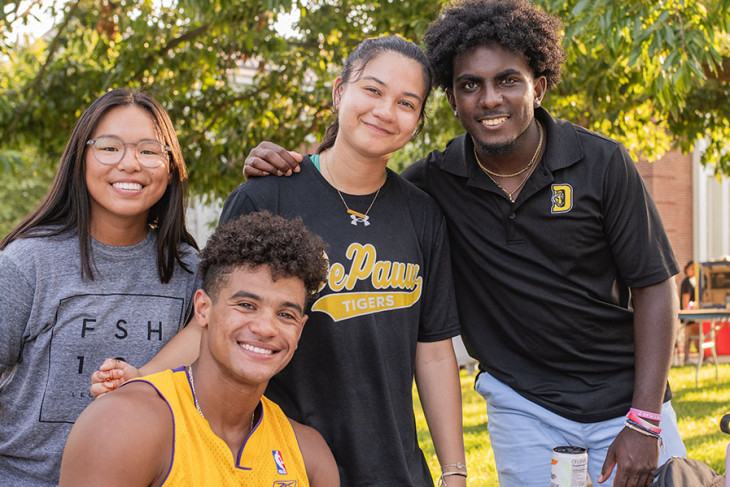 Students huddled together smiling