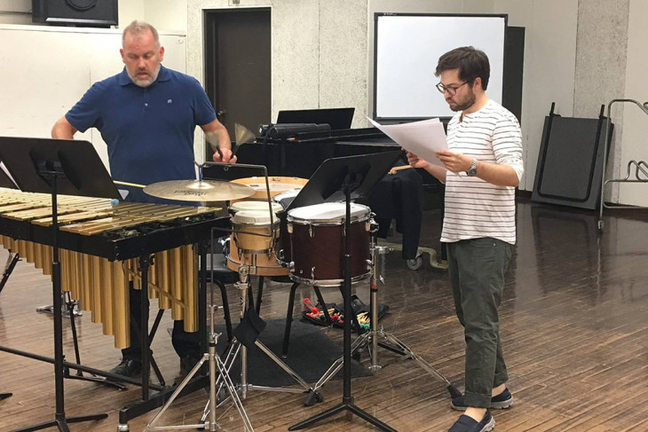 Man reading music next to a man playing vibraphone