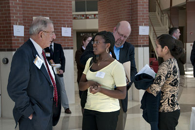 Students speaking to a professor outside of class