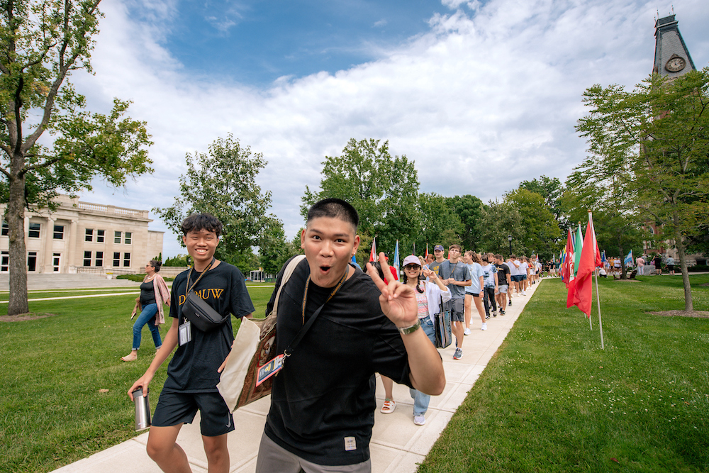 The opening day procession passes on East College lawn