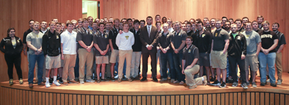 Andrew Luck on stage with the football team